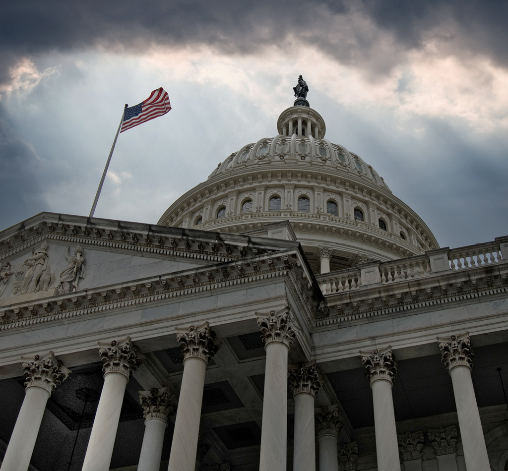 Image of U.S. Capitol building with cloudy skies above.